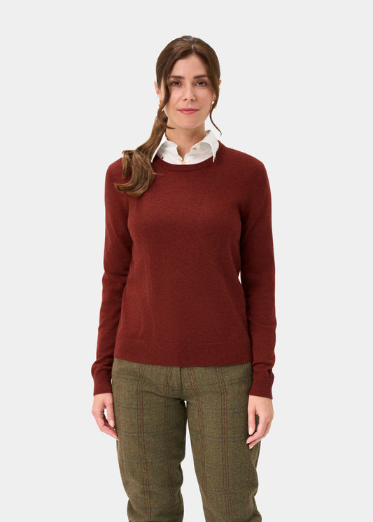 Woman with brown hair in a side ponytail wears the Ivy Wool & Cashmere Crew Neck Jumper In Autumn, white shirt, plaid pants.