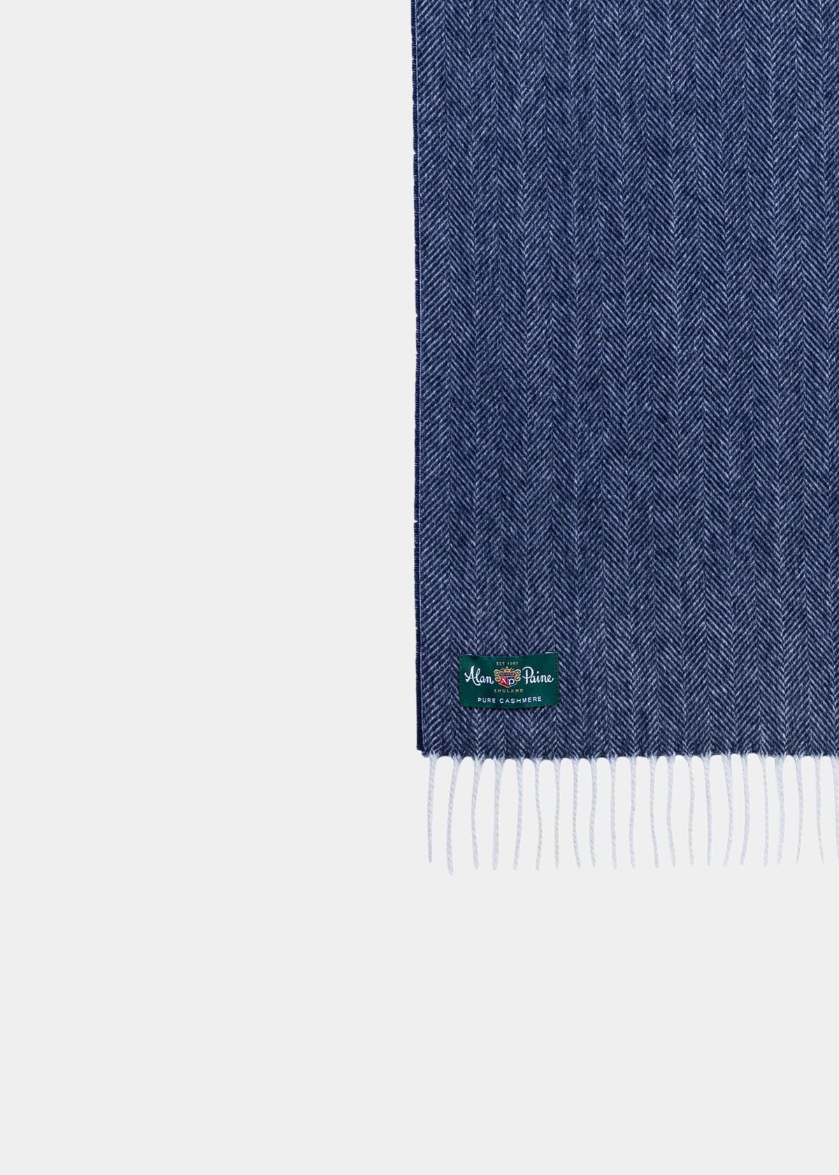 Kinross Cashmere Herringbone Scarf in Indigo with fringed ends and green label adds a touch of elegance.