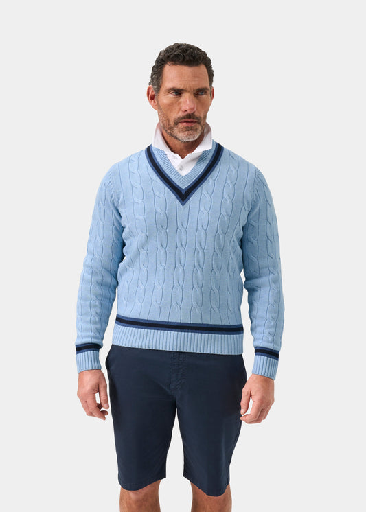 Steel blue cotton cable knit V-neck jumper with dark navy trim, worn over white shirt, front view