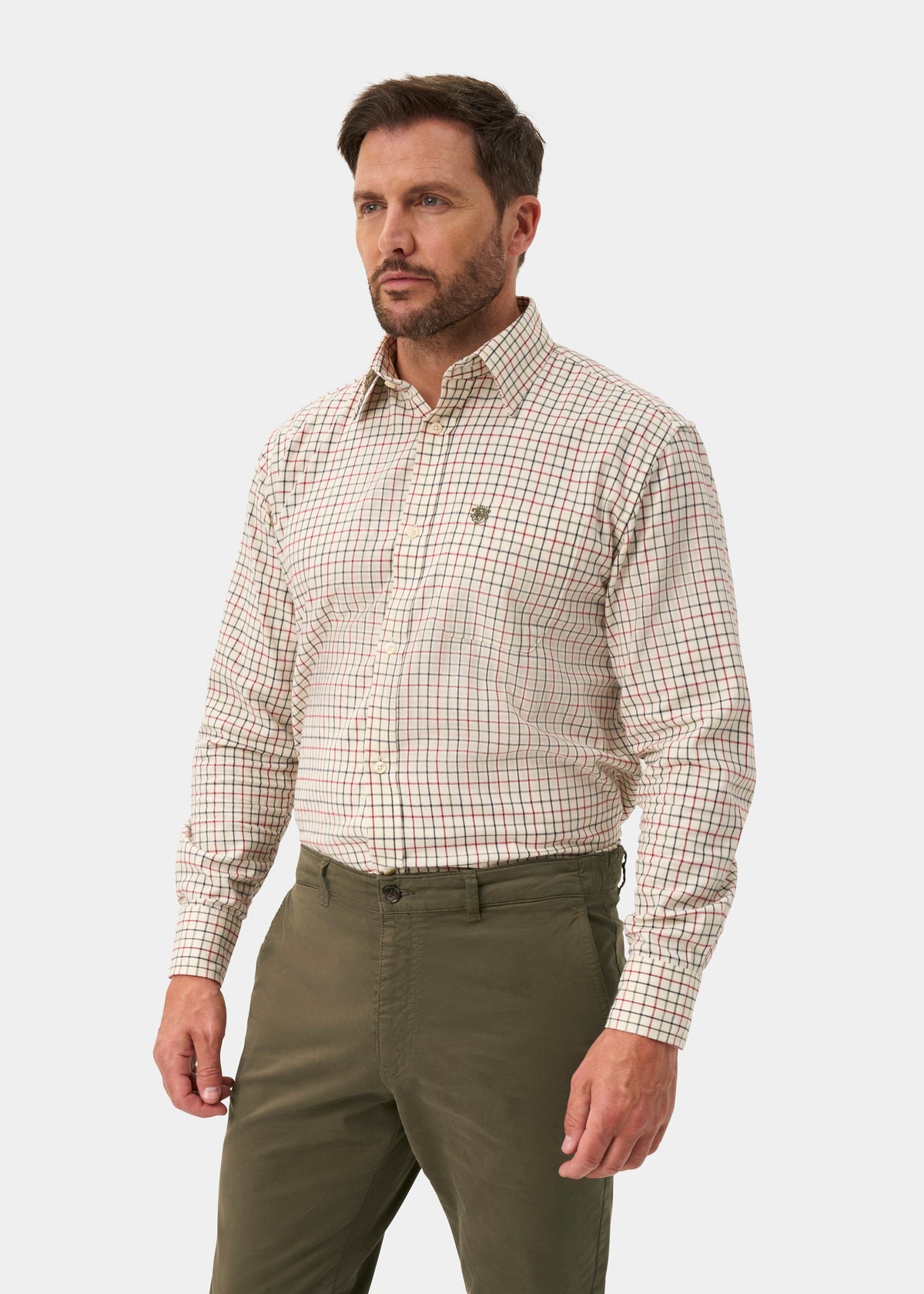 Man wears Ilkley Men’s Cotton Country Check Shirt in Red, shooting fit, against a plain white background.