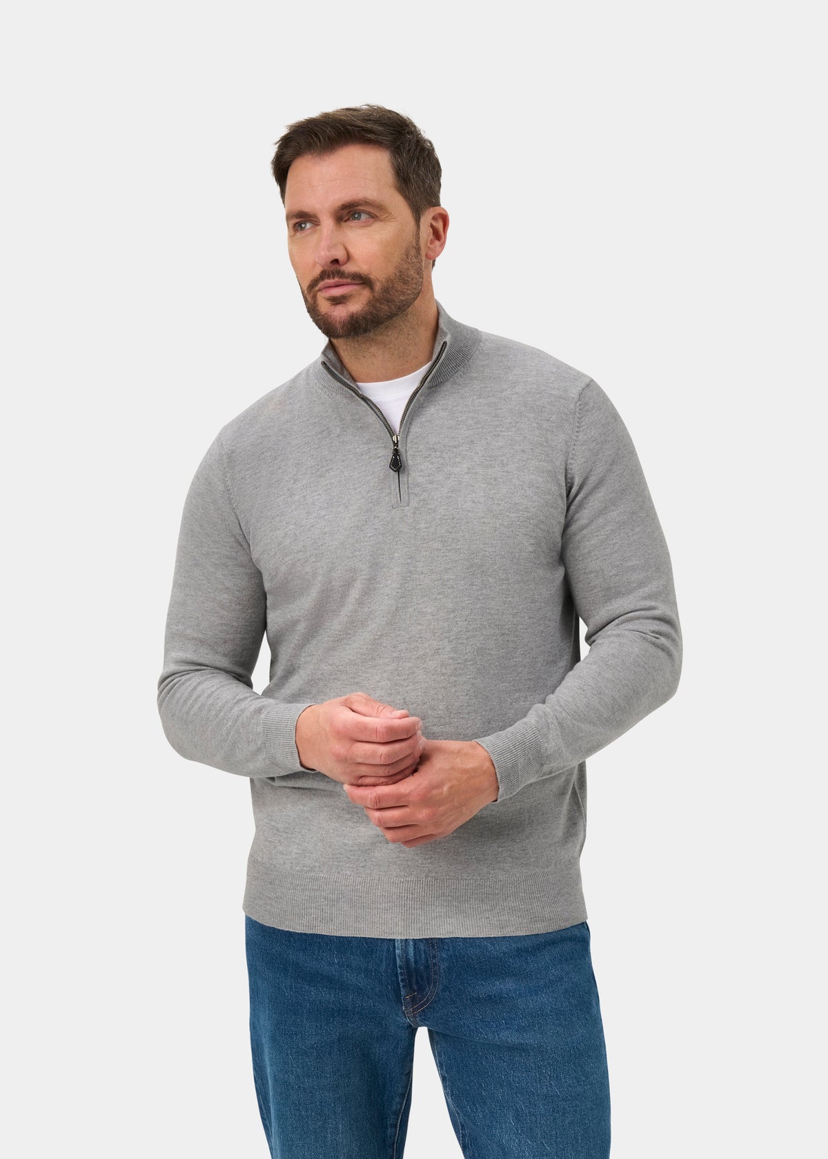 Man wears Ashfield Cotton Merino Quarter Zip Jumper in Light Grey Mix, regular fit, with blue jeans on white background.