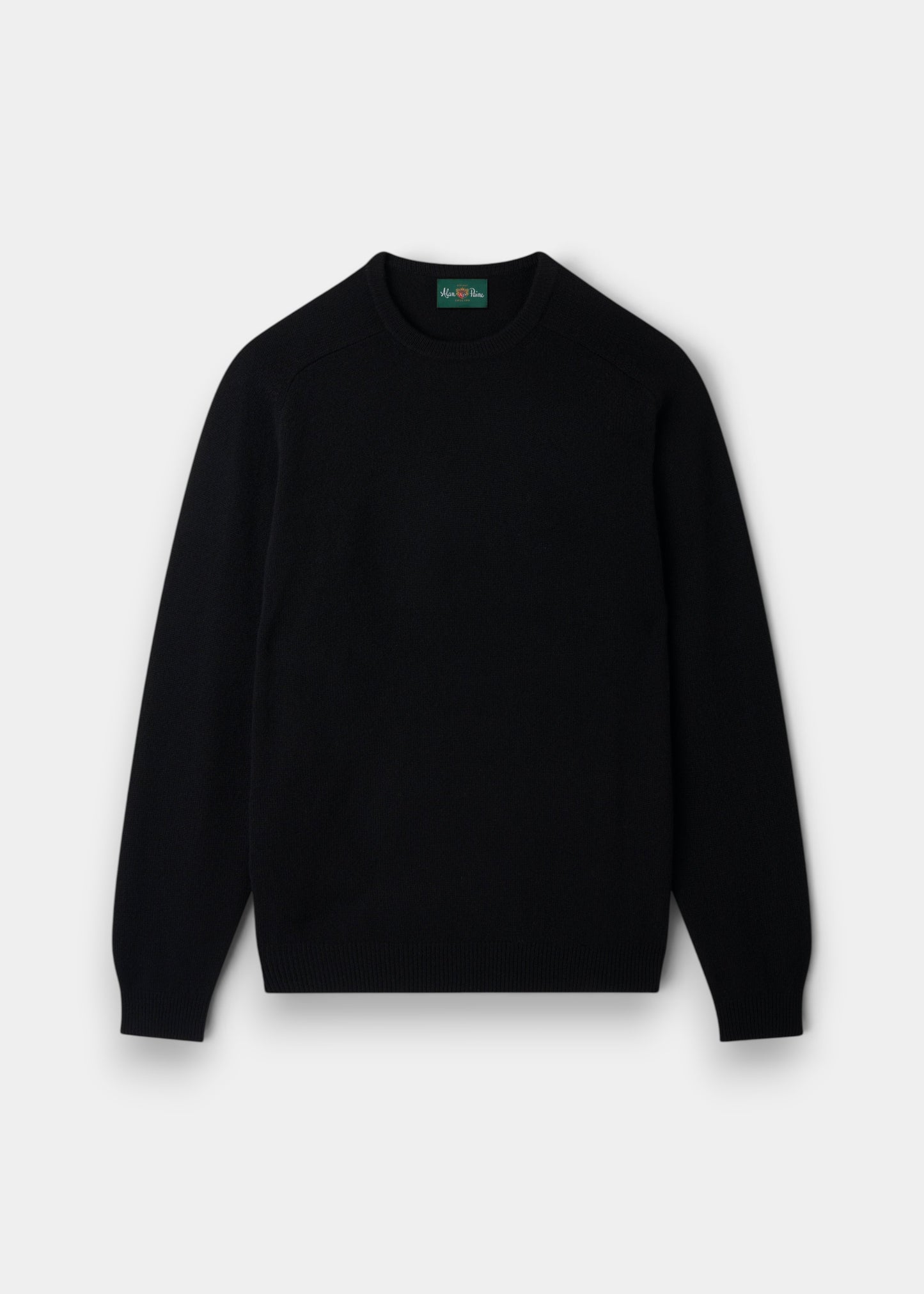 Alan Paine Lenzie men's black crew neck jumper in soft lambswool with saddle shoulder detailing and ribbed cuffs.