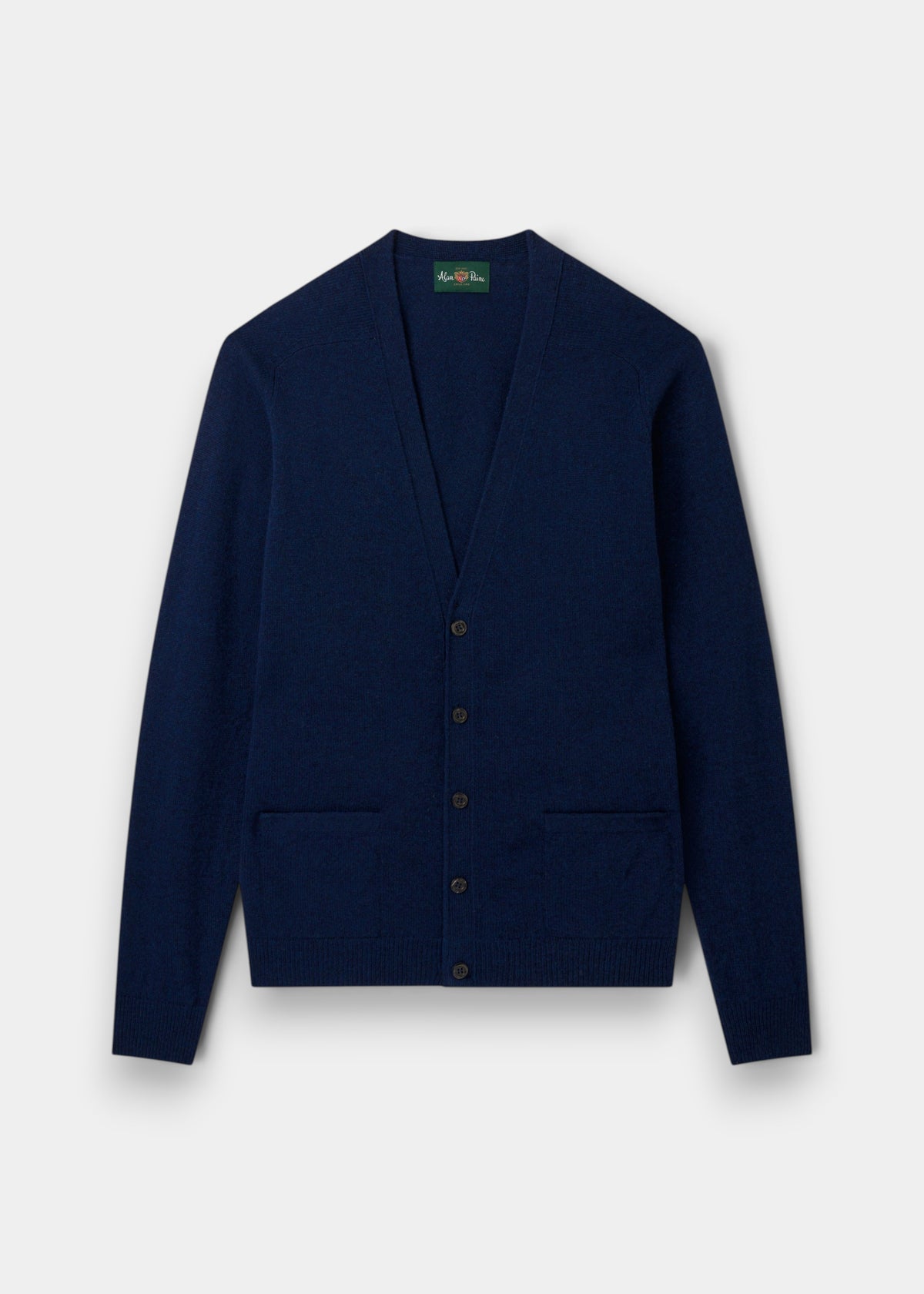 Cornwall Lambswool V-Neck Cardigan in Indigo, classic fit, long sleeves, two pockets, laid flat on light background.