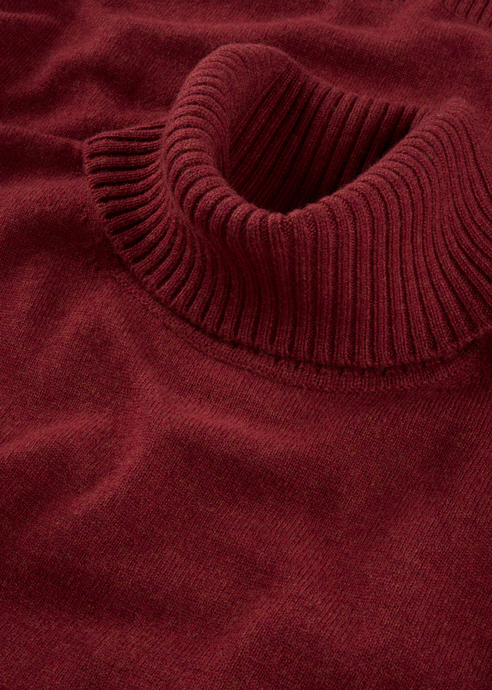 Alexa Ladies Wool and Cashmere Roll Neck in Berry with ribbed collar and soft knit texture shown close up.