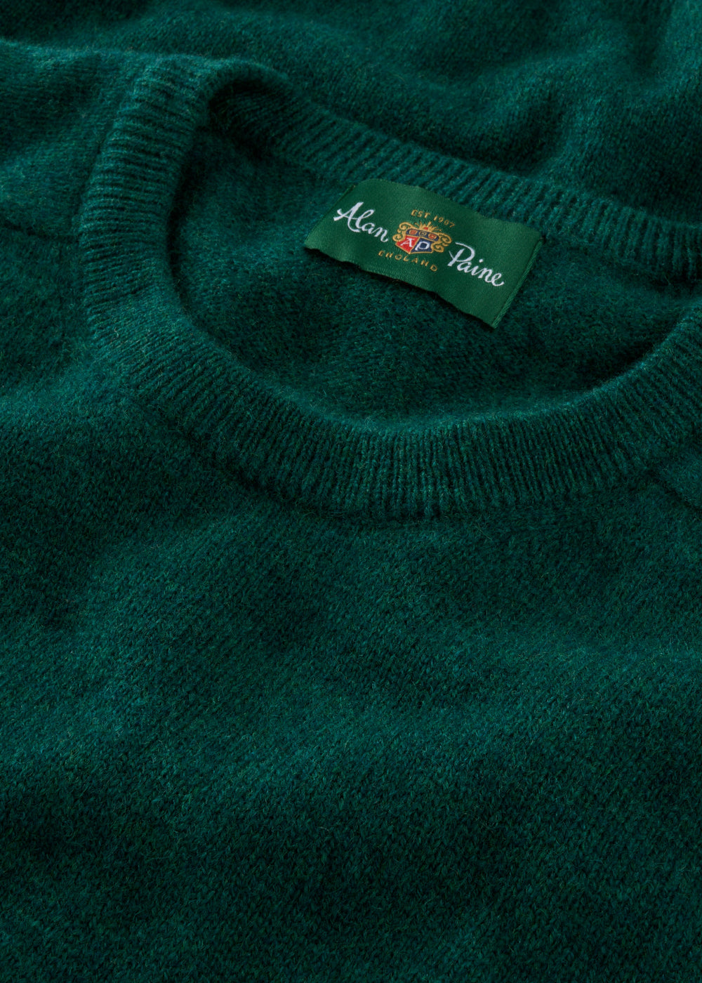 Close-up of Dorset Lambswool Crew Neck Jumper in Mallard, showing its soft texture and classic fit label on the collar.