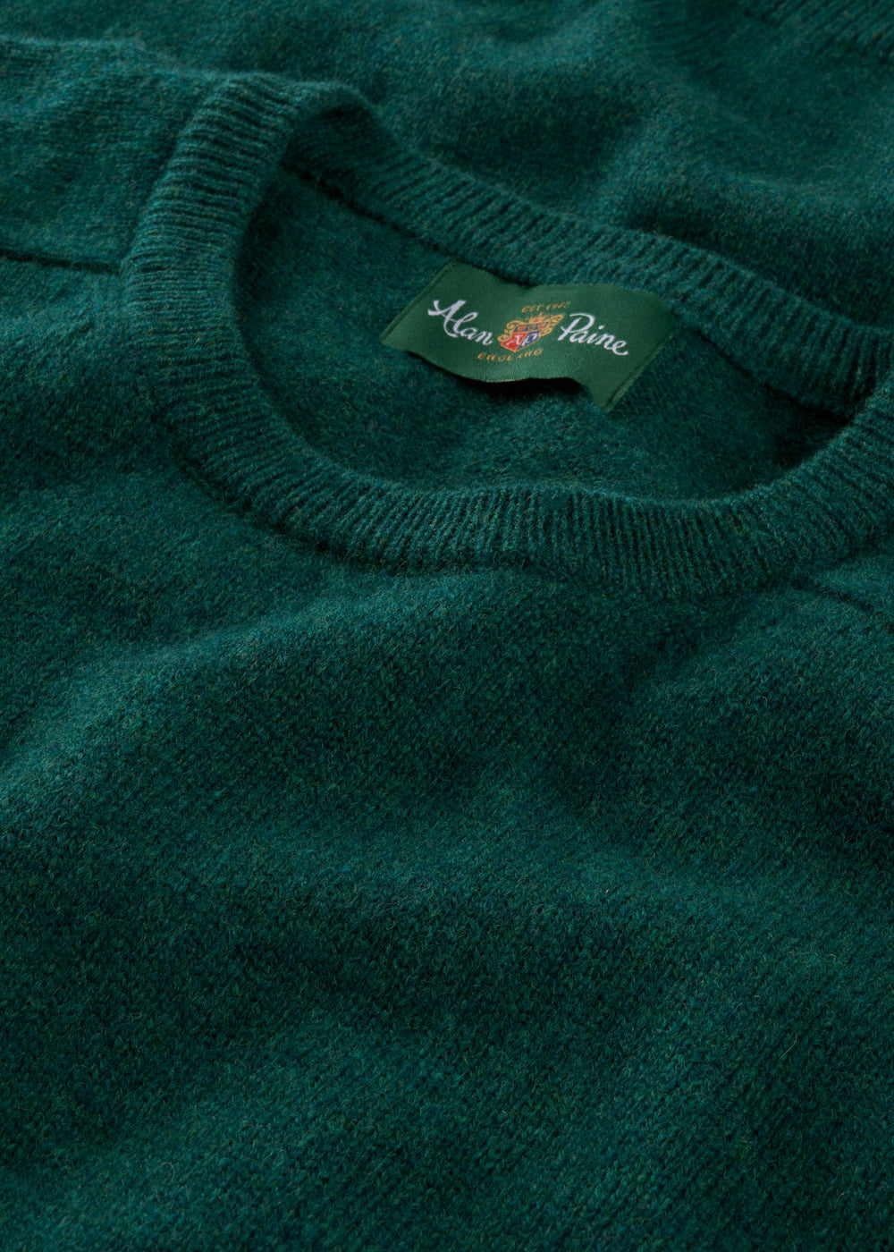 A close-up of the Lenzie Lambswool Crew Neck Jumper in Mallard, highlighting the crew neck and woven texture.